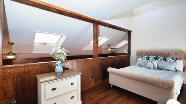 a bedroom with furniture and a mirror