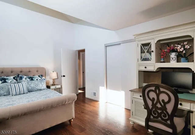 a bedroom with furniture and wooden floor