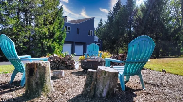 a view of a house with backyard and sitting area