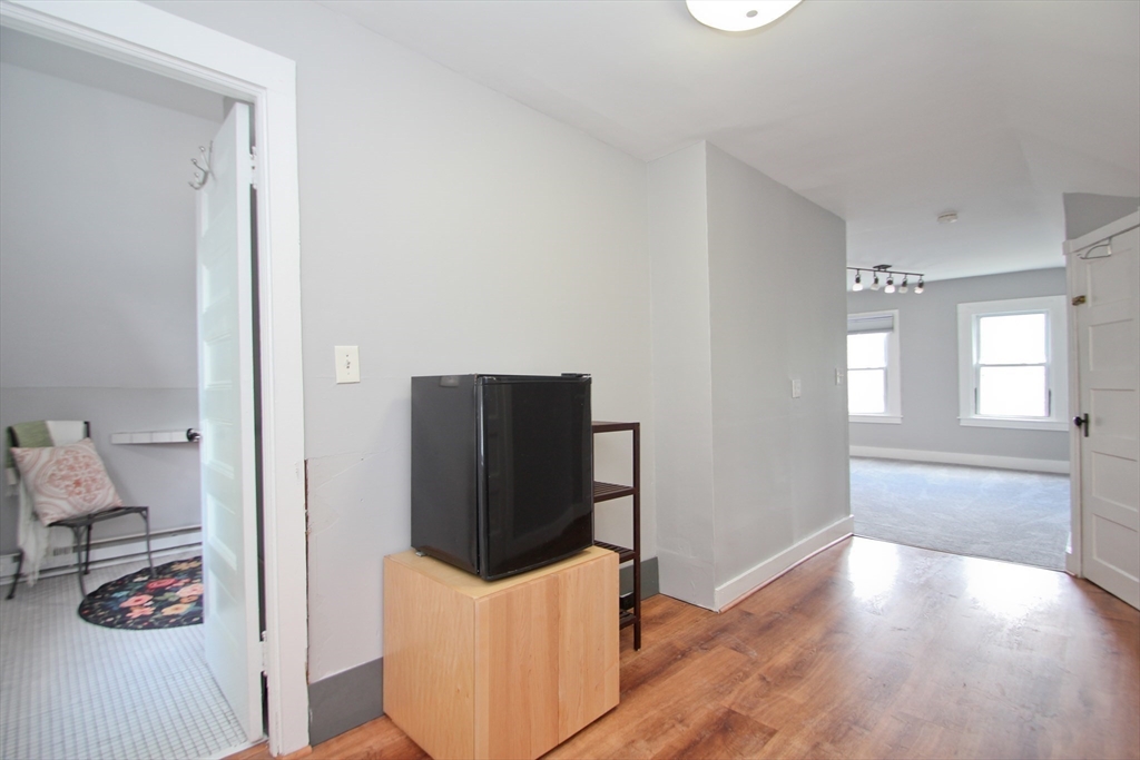 38 Virginia Street Springfield, MA 01108 - Photo 27 of 42 a view of kitchen with refrigerator and wooden floor