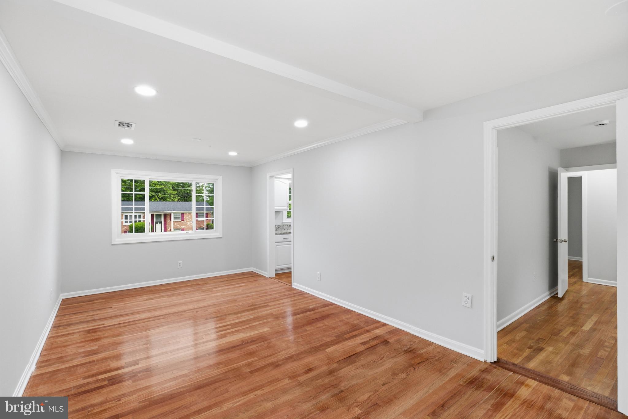 14033 Grayson Road Woodbridge, VA 22191 - Photo 12 of 33 a view of an empty room with wooden floor and a window