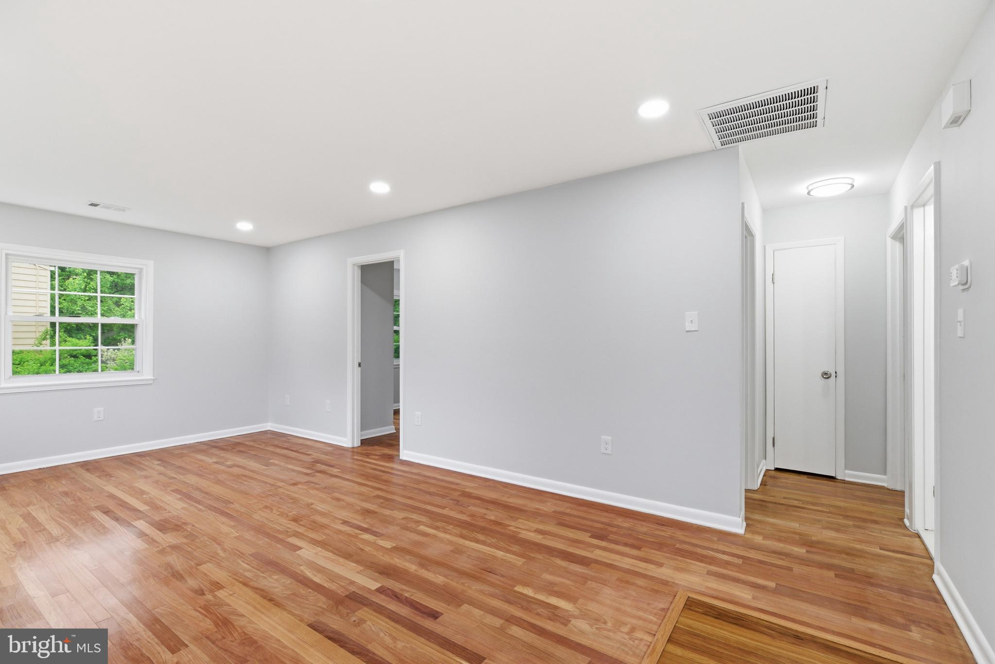 14033 Grayson Road Woodbridge, VA 22191 - Photo 13 of 33 a view of an empty room with wooden floor and a window