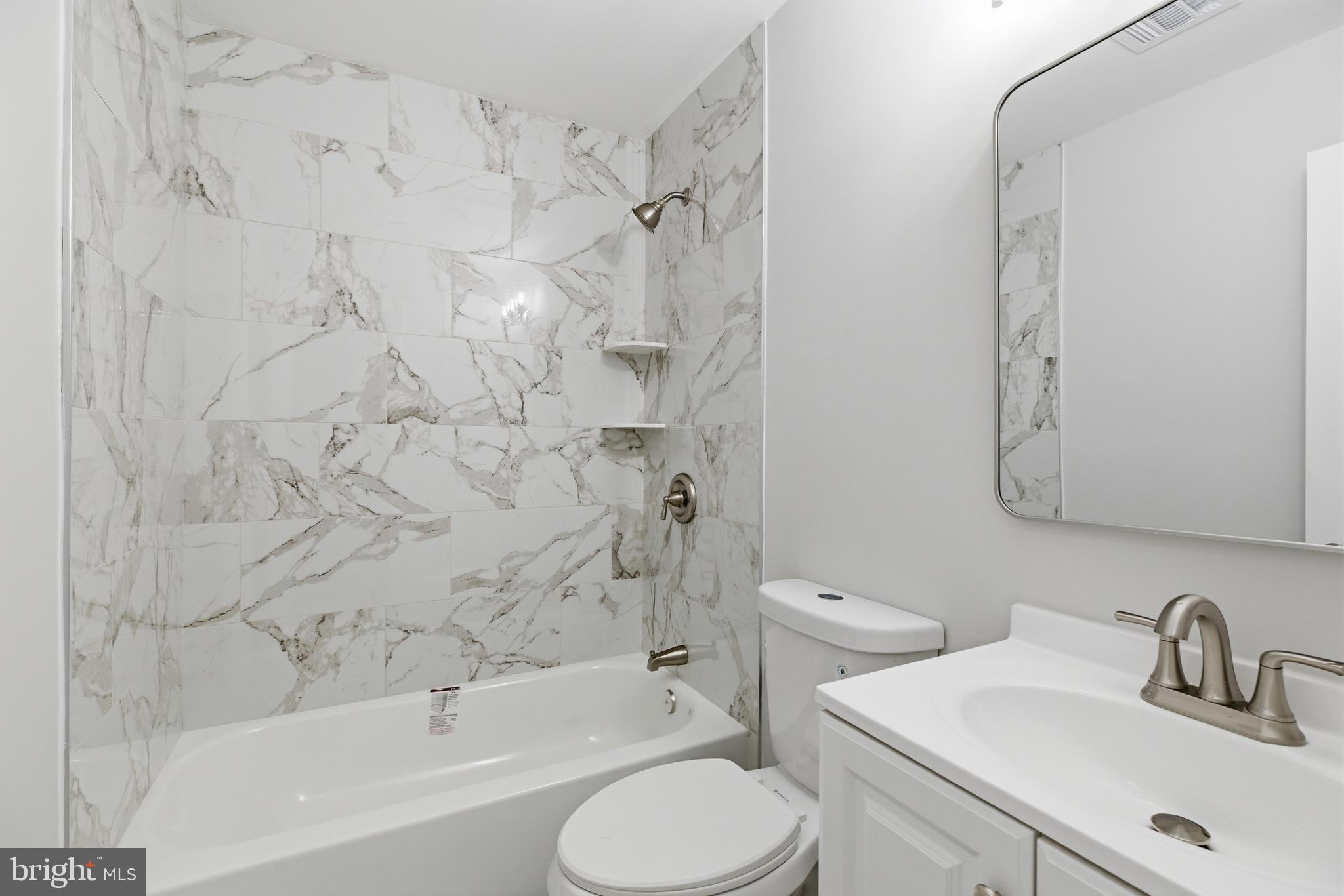 14033 Grayson Road Woodbridge, VA 22191 - Photo 20 of 33 a bathroom with a sink toilet and shower