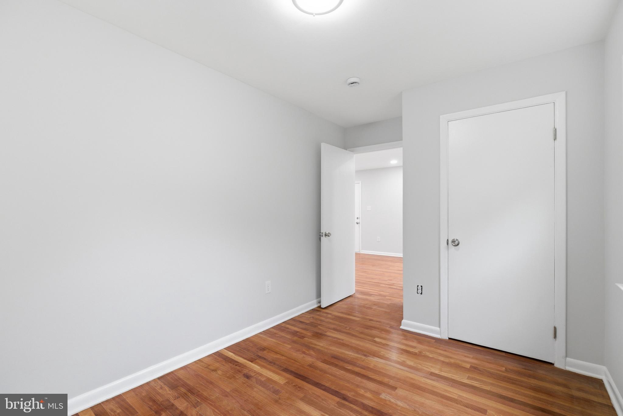 14033 Grayson Road Woodbridge, VA 22191 - Photo 22 of 33 a view of an empty room with wooden floor