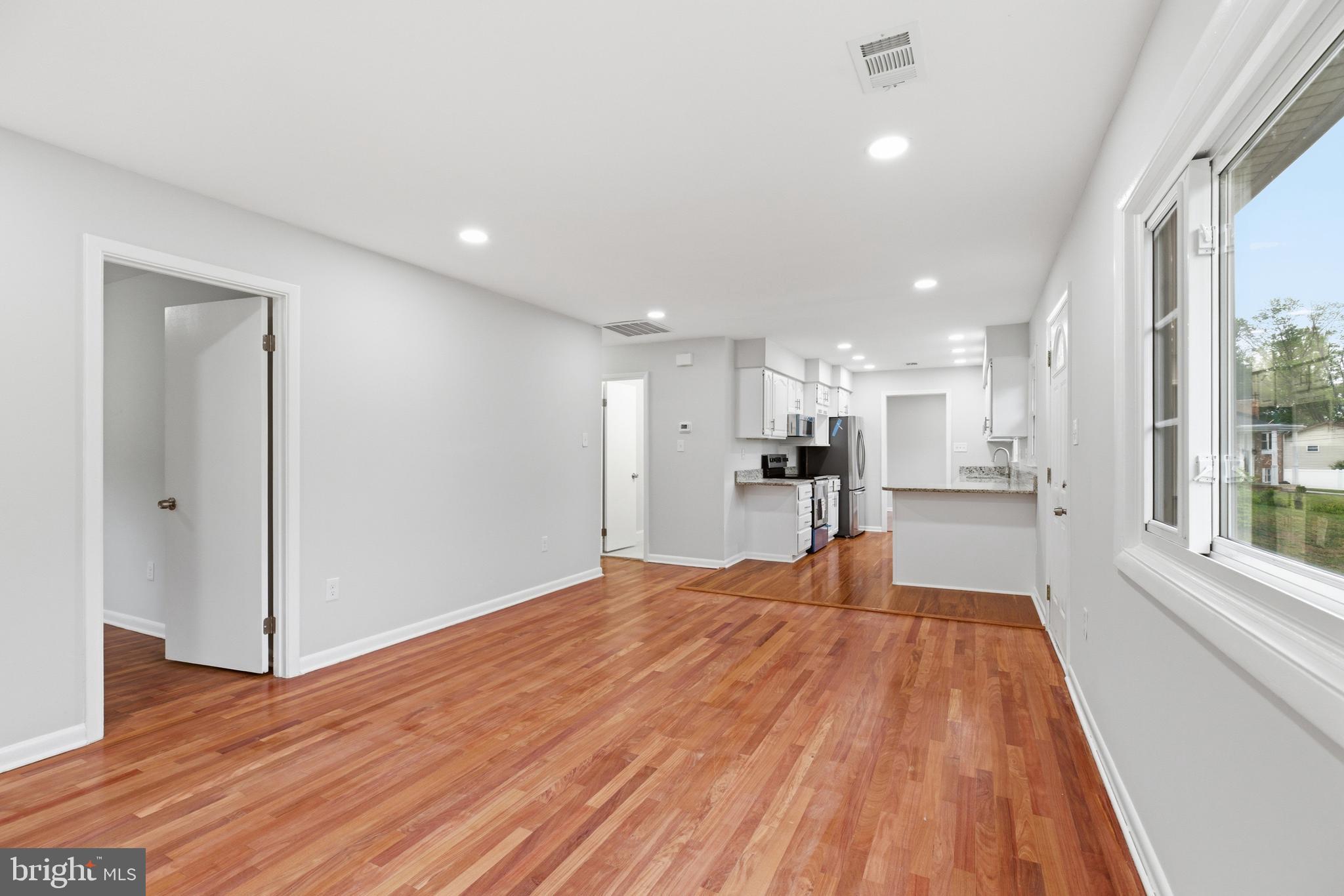 14033 Grayson Road Woodbridge, VA 22191 - Photo 4 of 33 a big room with wooden floor and windows