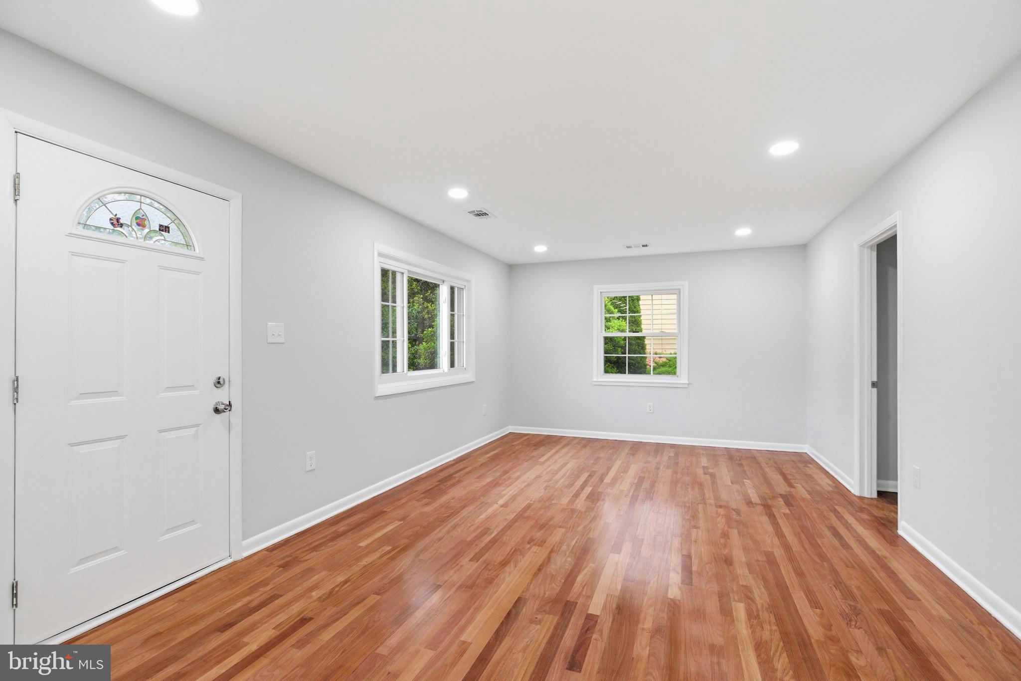 14033 Grayson Road Woodbridge, VA 22191 - Photo 5 of 33 an empty room with wooden floor and windows