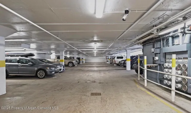 a view of parking garage with cars