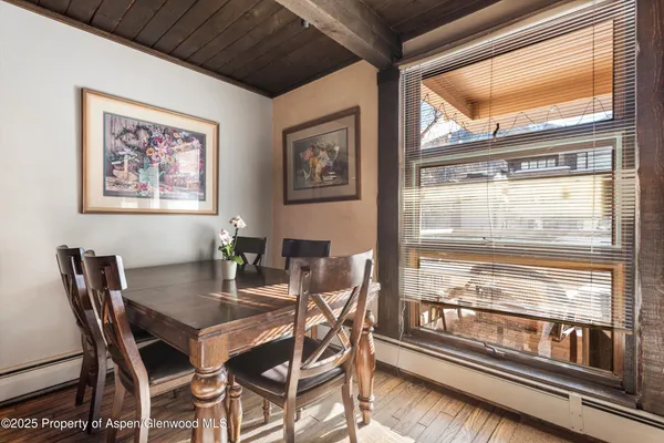 a view of a dining room with furniture wooden floor and kitchen view