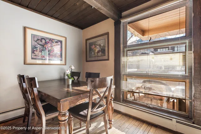 a view of a dining room with furniture wooden floor and kitchen view
