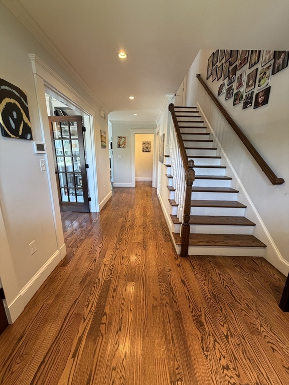 17 Cardinal Street, Unit 17 Winchester, MA 01890 - Photo 3 of 42 a view of a hallway with wooden floor and staircase