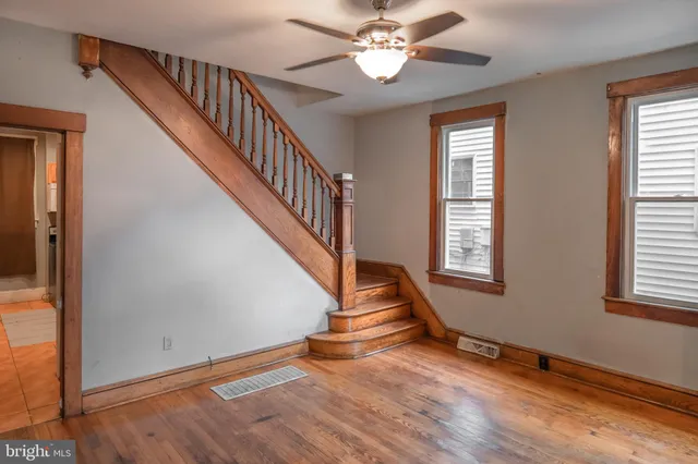 wooden floor in an empty room with a window and wooden floor