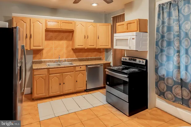 a kitchen with stainless steel appliances a stove sink and cabinets
