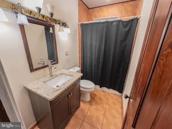 a bathroom with a sink a toilet and mirror