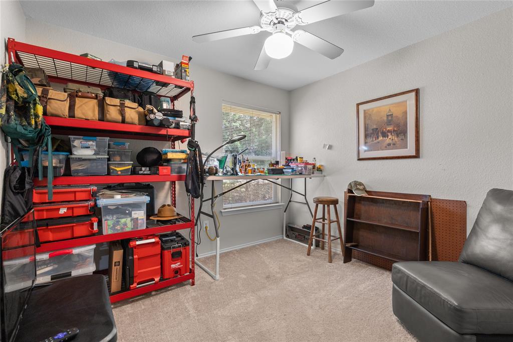 1007 Santa Fe Street Denton, TX 76205 - Photo 23 of 37 a bedroom with furniture and a baby crib