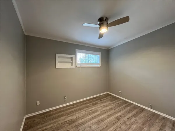 a view of empty room with wooden floor
