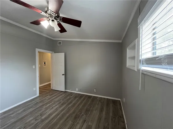wooden floor in an empty room with a window