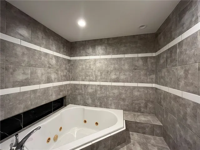 a bathroom with a bathtub and shower