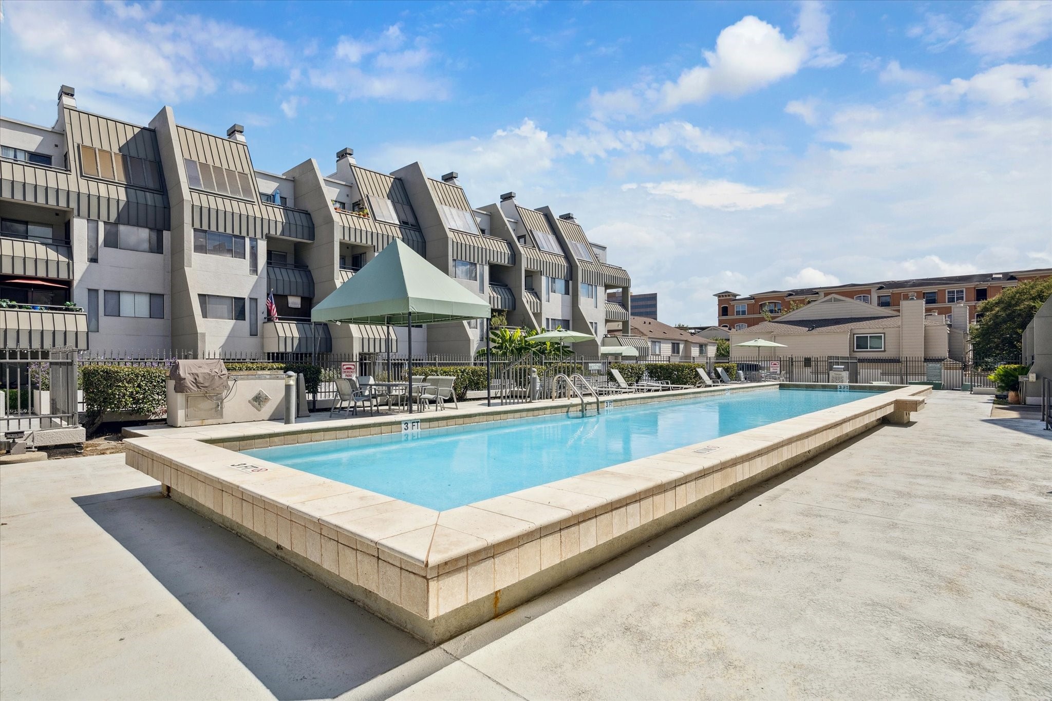 1819 Augusta Drive, Unit C28 Houston, TX 77057 - Photo 14 of 17 a view of swimming pool with outdoor seating and city view
