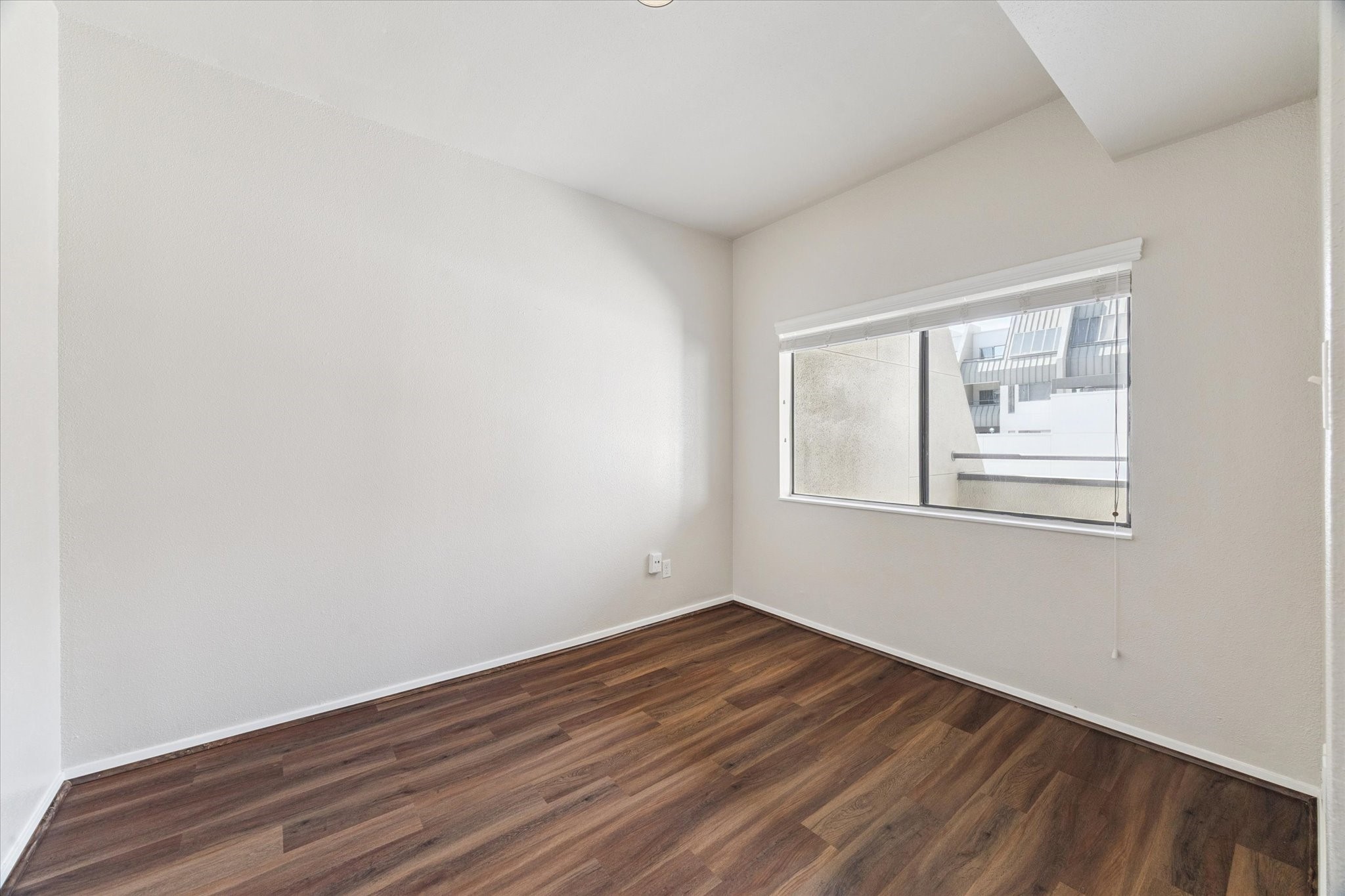 1819 Augusta Drive, Unit C28 Houston, TX 77057 - Photo 8 of 17 a view of an empty room with wooden floor and a window