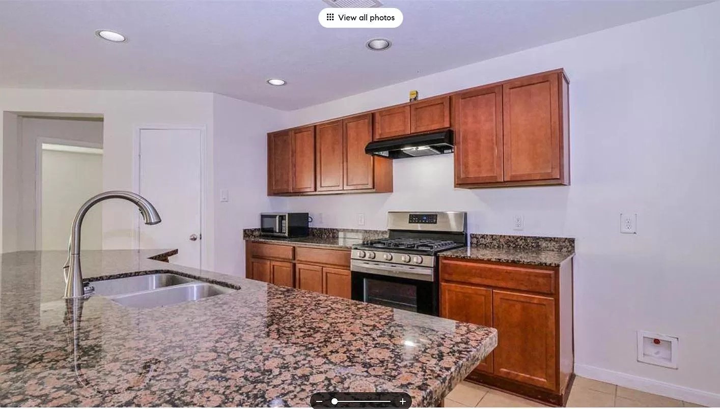 15331 Keystone Bend Lane Cypress, TX 77429 - Photo 5 of 18 a kitchen with sink a stove and cabinets