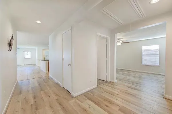a view of a room with wooden floor and a bathroom