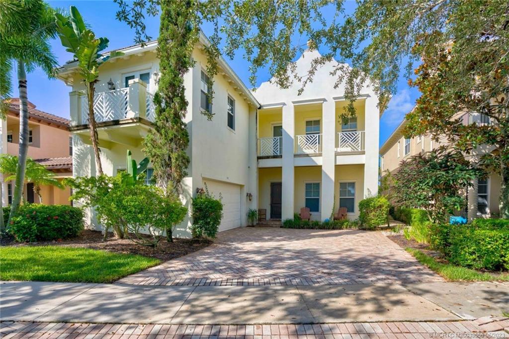 108 Tulip Tree Court Jupiter, FL 33458 - Photo 1 of 41 a view of a brick building next to a yard