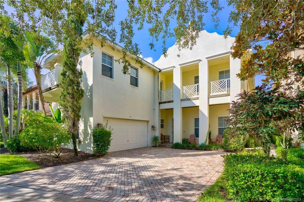 108 Tulip Tree Court Jupiter, FL 33458 - Photo 3 of 41 a front view of a house with a yard and a garage