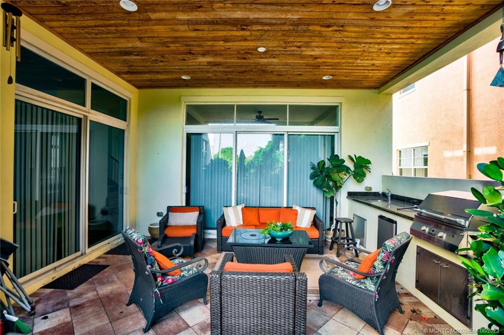 108 Tulip Tree Court Jupiter, FL 33458 - Photo 6 of 41 a outdoor space with patio the couches and a dining table with the potted plants