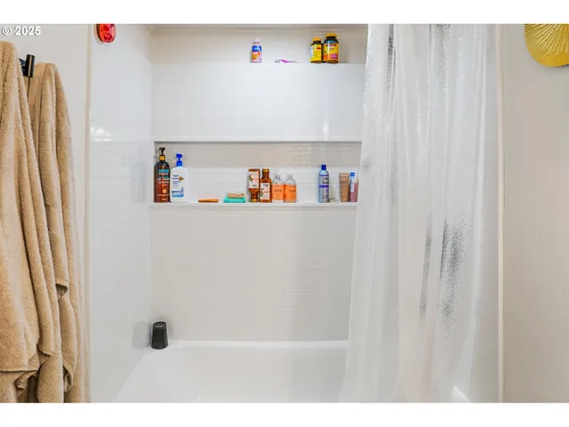 a bedroom with a bed and painting on the wall