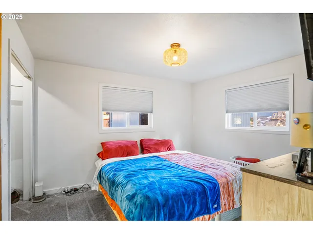 a bedroom with a bed and a dresser