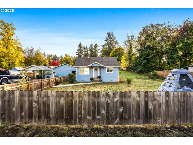 a view of a house with wooden fence