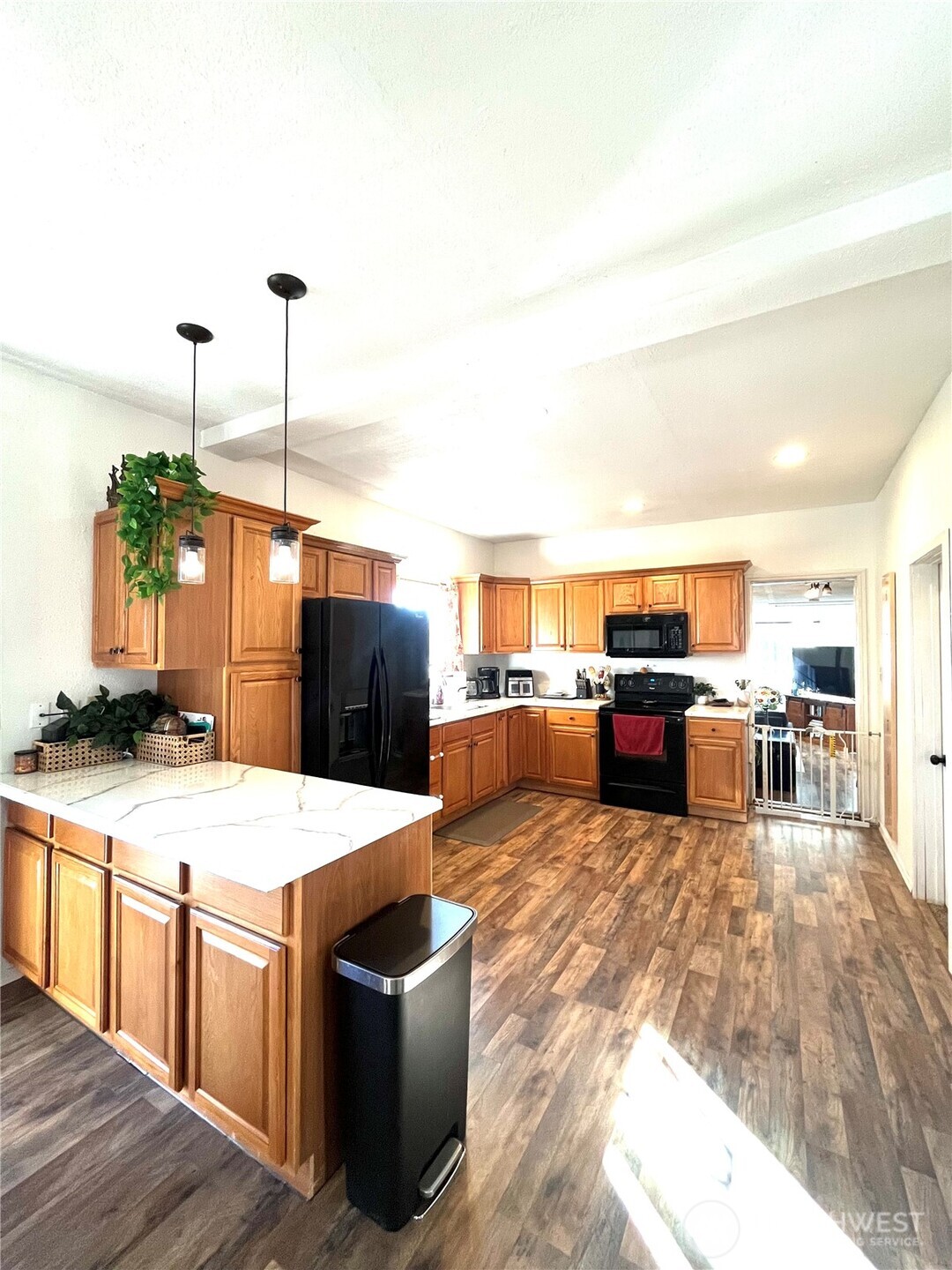 302 Centre Street North Rainier, WA 98576 - Photo 9 of 28 a living room with stainless steel appliances kitchen island granite countertop a table chairs and a view of living room