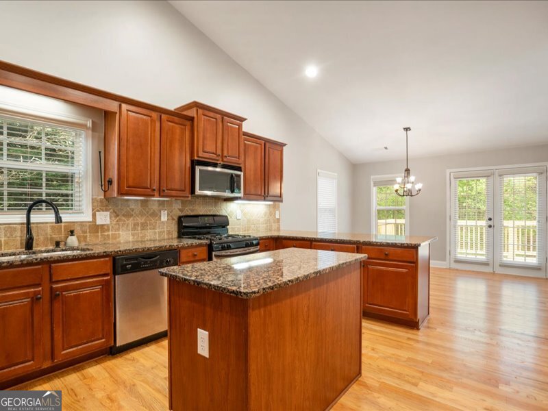 1406 Morgans Bluff Monroe, GA 30656 - Photo 16 of 80 a kitchen with stainless steel appliances granite countertop a sink stove and microwave