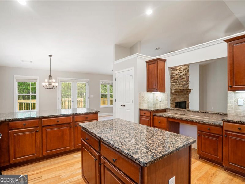 1406 Morgans Bluff Monroe, GA 30656 - Photo 17 of 80 a kitchen with stainless steel appliances granite countertop wooden cabinets and a granite counter tops with a large window