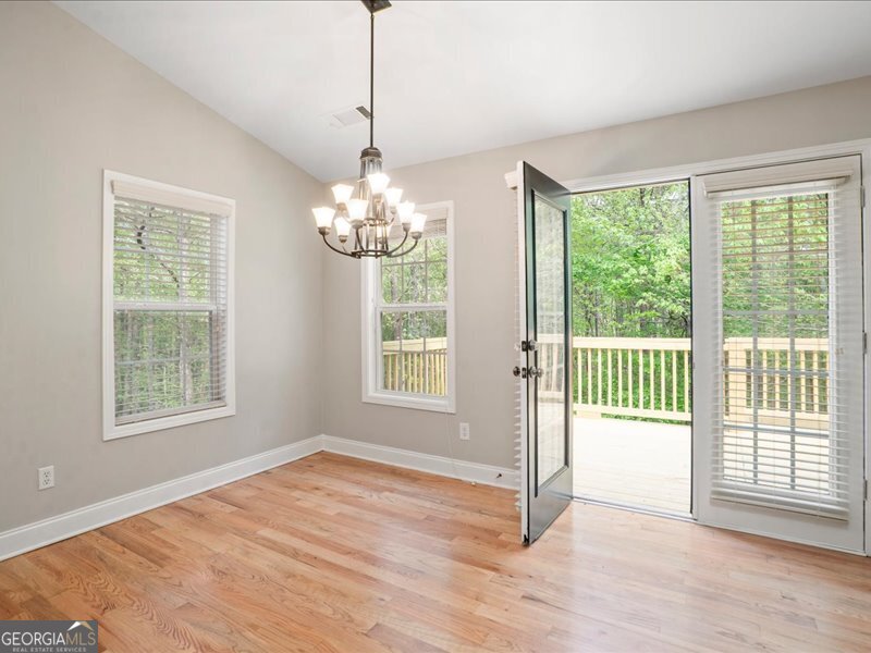 1406 Morgans Bluff Monroe, GA 30656 - Photo 20 of 80 a view of an empty room with wooden floor and a window