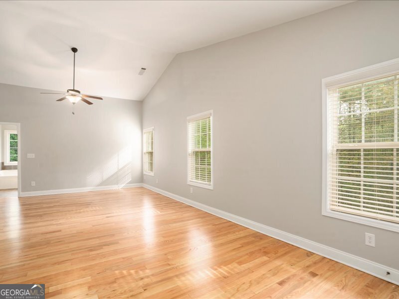 1406 Morgans Bluff Monroe, GA 30656 - Photo 22 of 80 a view of an empty room with wooden floor and a window