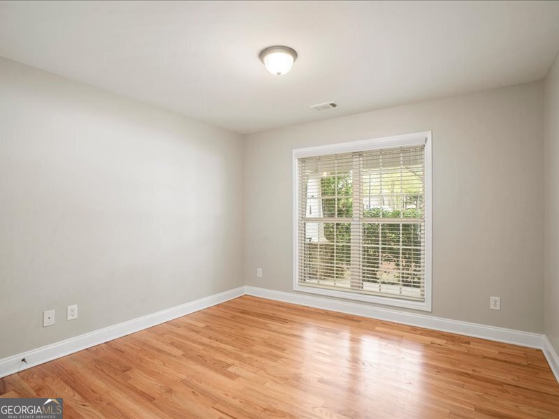 1406 Morgans Bluff Monroe, GA 30656 - Photo 24 of 80 an empty room with wooden floor and windows