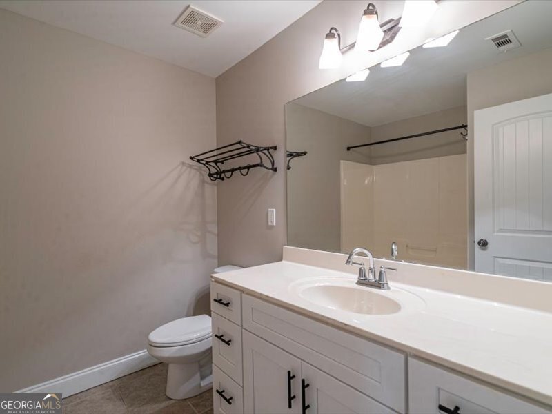1406 Morgans Bluff Monroe, GA 30656 - Photo 27 of 80 a bathroom with a toilet sink and mirror
