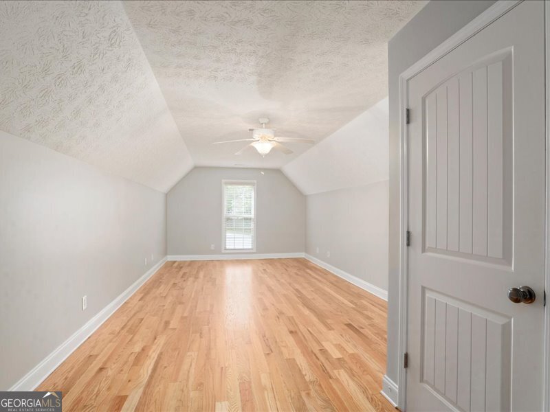 1406 Morgans Bluff Monroe, GA 30656 - Photo 30 of 80 wooden floor in an empty room with a window