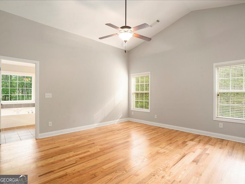 1406 Morgans Bluff Monroe, GA 30656 - Photo 32 of 80 an empty room with wooden floor and windows