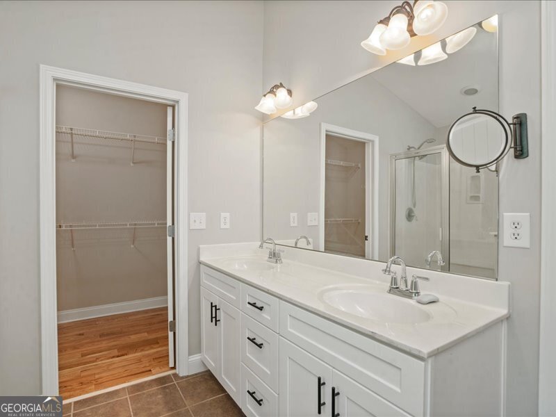 1406 Morgans Bluff Monroe, GA 30656 - Photo 35 of 80 a bathroom with a double vanity sink and a mirror