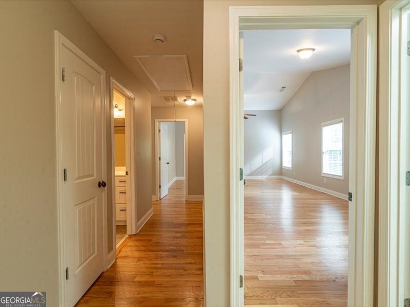 1406 Morgans Bluff Monroe, GA 30656 - Photo 39 of 80 a view of a hallway with wooden floor and staircase