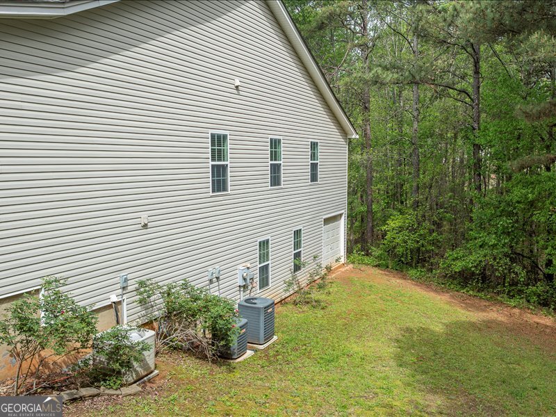 1406 Morgans Bluff Monroe, GA 30656 - Photo 73 of 80 a view of a backyard with plants and large trees