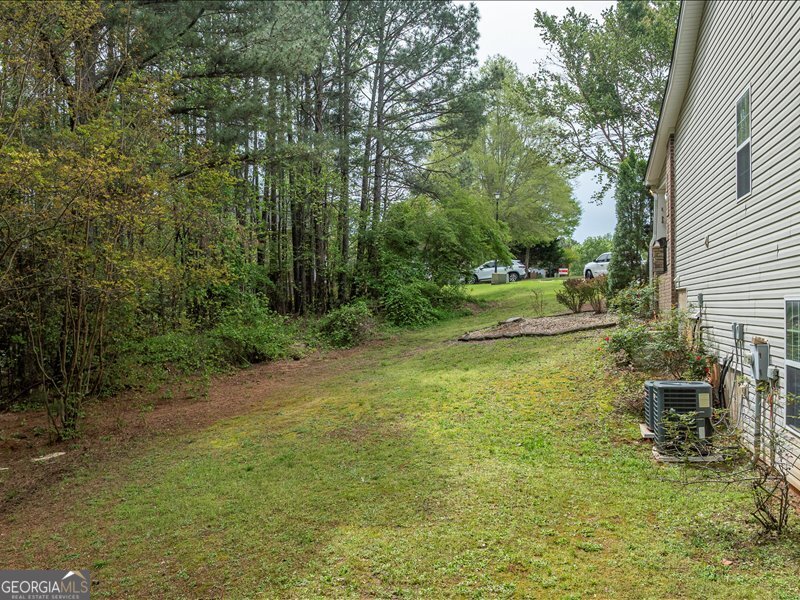1406 Morgans Bluff Monroe, GA 30656 - Photo 74 of 80 a backyard of a house with table and chairs