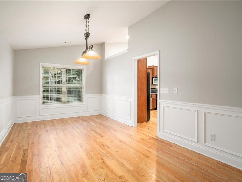 1406 Morgans Bluff Monroe, GA 30656 - Photo 8 of 80 a view of an empty room with wooden floor and a window