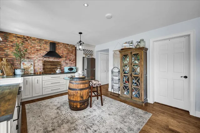 a very nice looking living room with a dining table and a large window with garden view