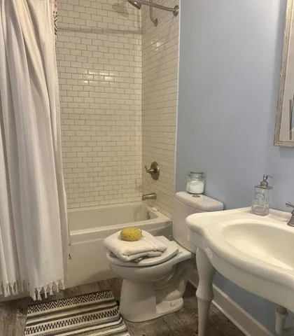 a bathroom with a sink toilet and a mirror