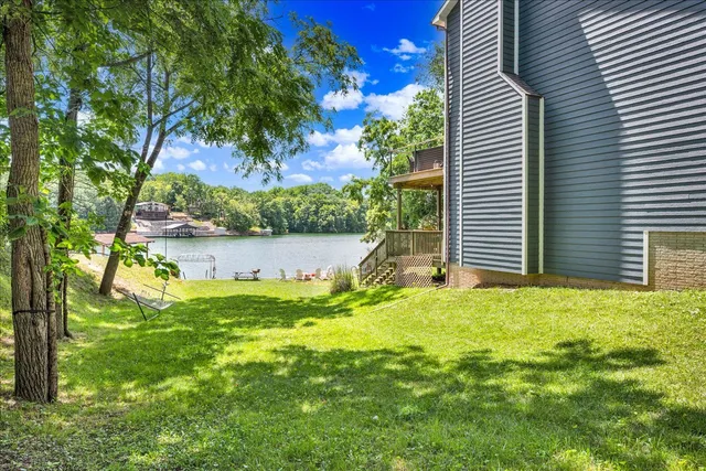 a backyard of a house with table and chairs