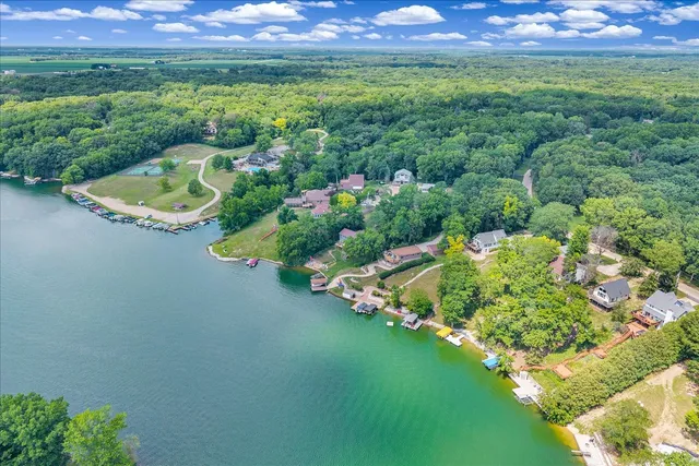 an aerial view of a houses with a lake view
