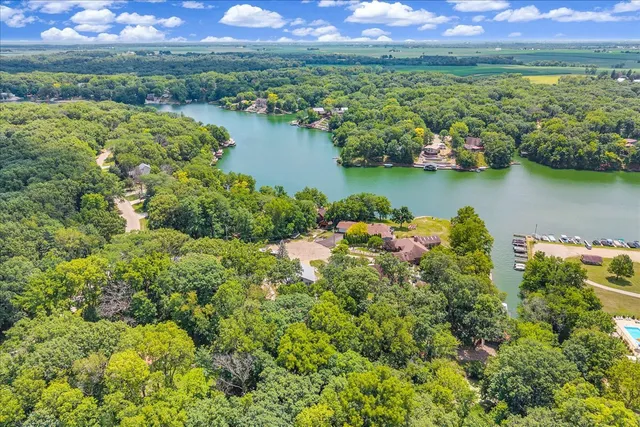 an aerial view of a house with a yard lake lake view and mountain view